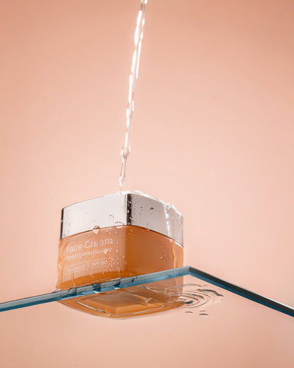 LYS Naturals Face Cream with SPF20 jar with a silver cap on a peach background