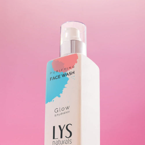 Bottle of LYS Naturals face wash on a pink background